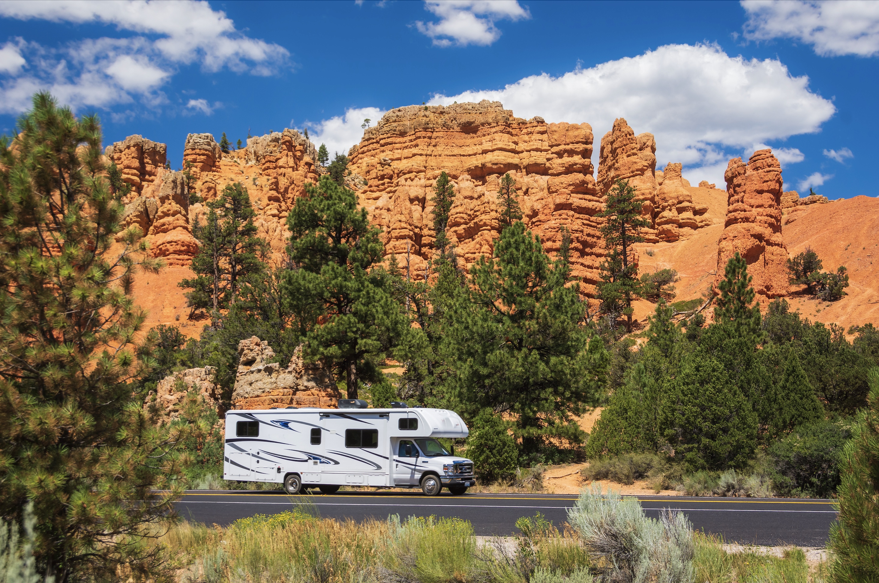 Class C motorhome on the road through red-rock country